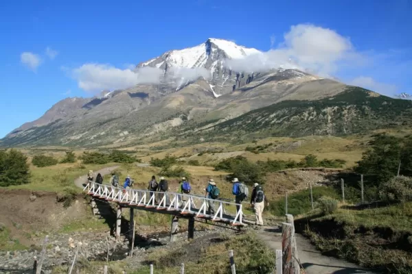 A trekking group crosses a creek in Torres del Paine 