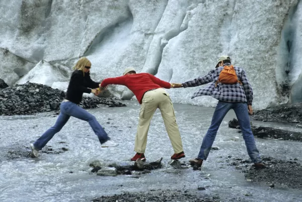 Travelers exploring a glacier on an Alaska tour
