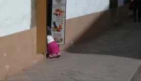 little Peruvian girl enters a shop