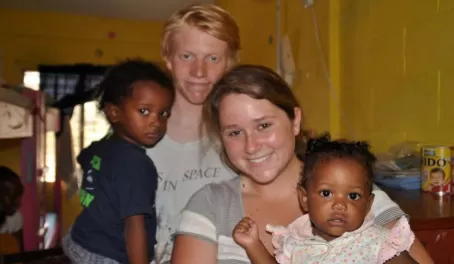 Lincoln and Sasha with kids in a Belize orphanage