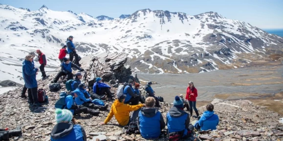 Travelers listening to fascinating talks from the expedition team