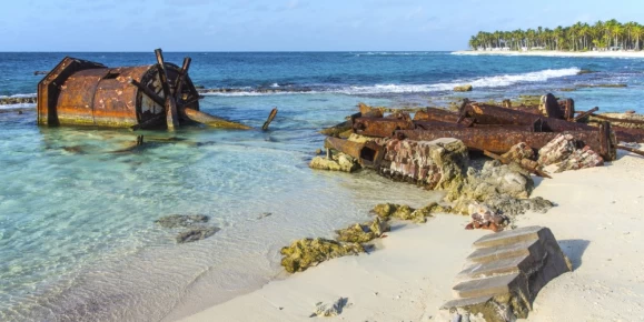 Rusting remains of the old lighthouse on Half Moon Caye, Lighthouse Reef Atoll, Belize Caribbean.