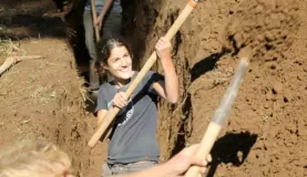 Volunteers dig the trench