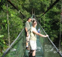 Crossing a suspension bridge while hiking Sarapiqui.