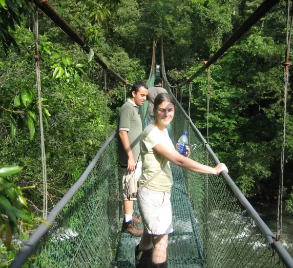 Crossing a suspension bridge while hiking Sarapiqui.