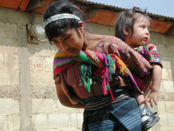 Maya woman carrying her toddler in the Guatemala Highlands
