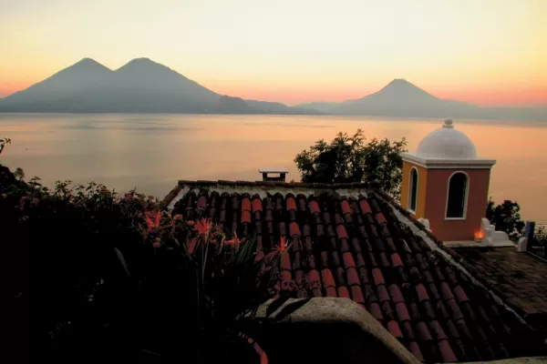 The sun sets behind the volcanoes around Lake Atitlan, Guatemala