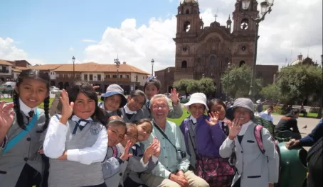 Students and their teacher pose for a photo in Peru