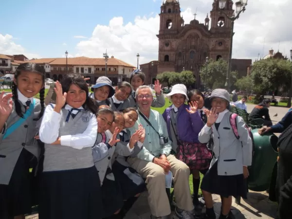 Students and their teacher pose for a photo in Peru