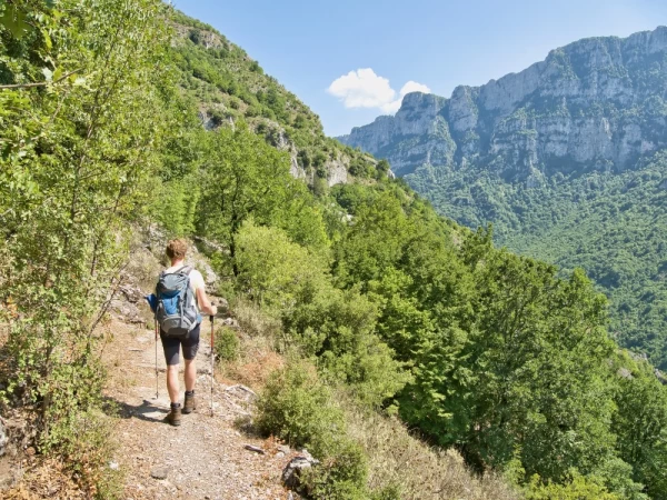 A young man walks through the Vikos Gorge from the Zagori village Monodendri to Papigko