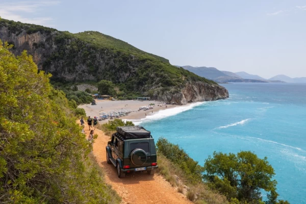Vehicles drive along the pathway to Gjipe Beach near Dhermi on the Ionian Sea in southern Albania