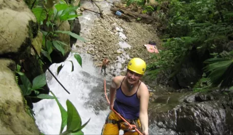 Rappelling down a waterfall at Selva Bananito