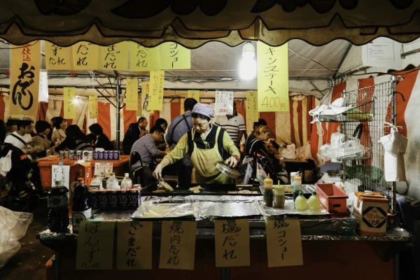 Local Japanese street food at night market in Tokyo, Japan