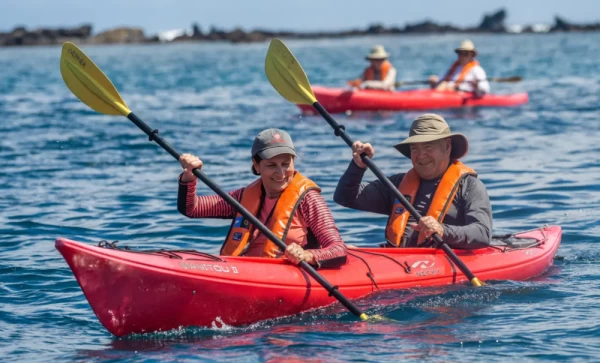 Kayak through the clear blue waters of  the Galapagos Islands.