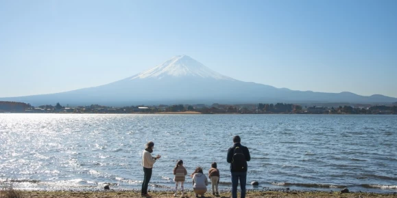 A family admiring the view of Mount Fuji at Lake Kawaguchiko in Yamanashi Prefecture in Japan