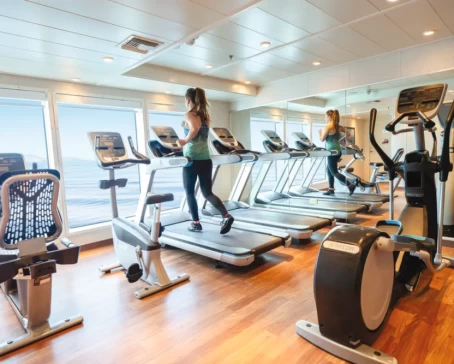 A guest enjoys the fitness center on the ship National Geographic Quest/Venture