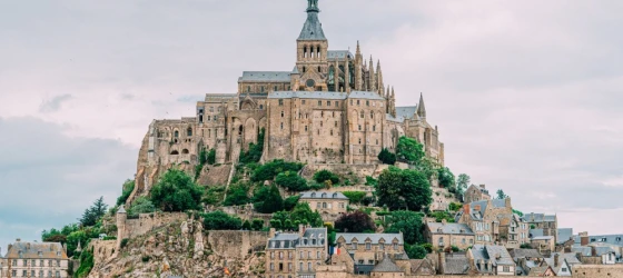 Mont Saint-Michel is a picturesque island commune in Normandy, France, renowned for its stunning medieval abbey perched atop a rocky hill