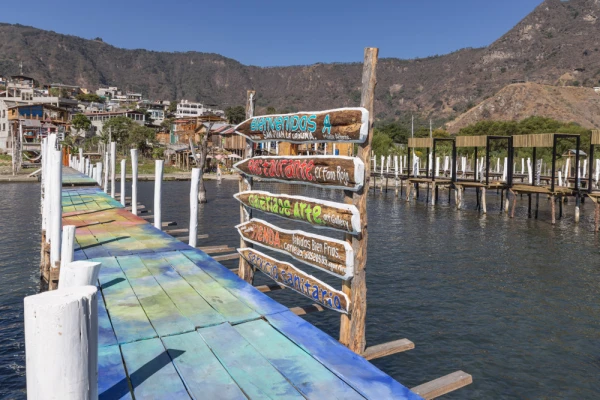 Signs for businesses on a dock on Lake Atitlan