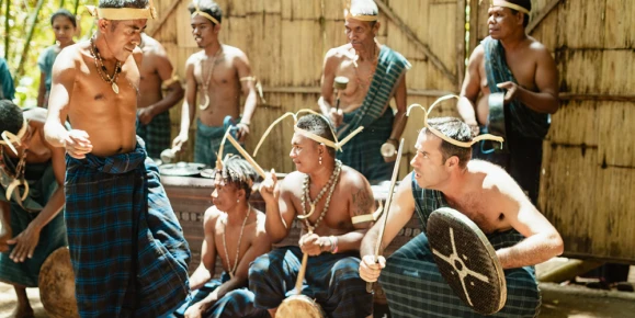 A group of local villagers playing traditional instruments in Forgotten Islands, Indonesia