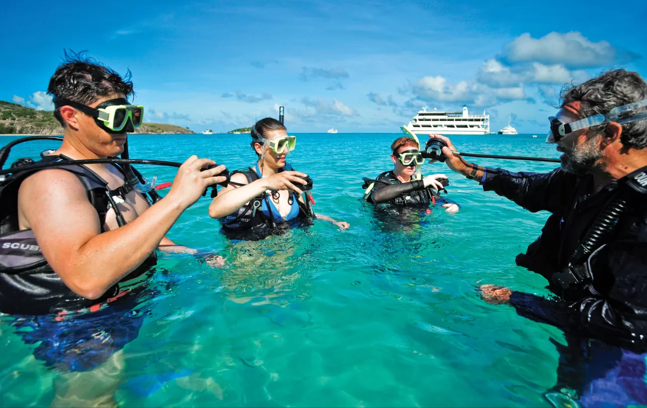 Travelers learning how to scuba dive.