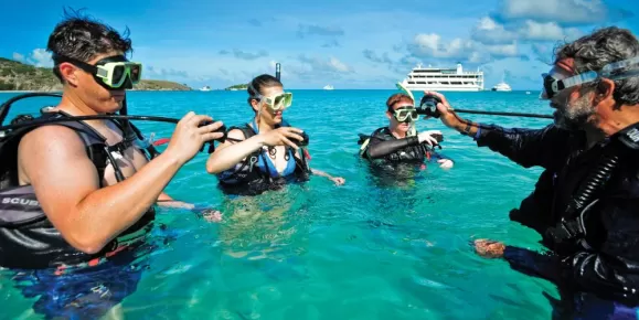 Travelers learning how to scuba dive.