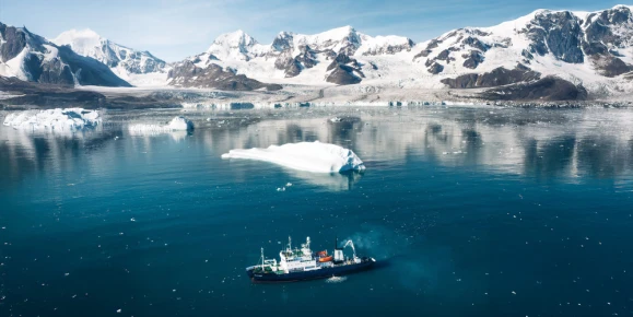 Polar Athena navigates icy blue waters surrounded by drifting icebergs