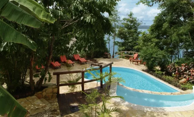 The pool perches above the casitas overlooking the lake