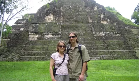 Travelers in front of ruins at Tikal
