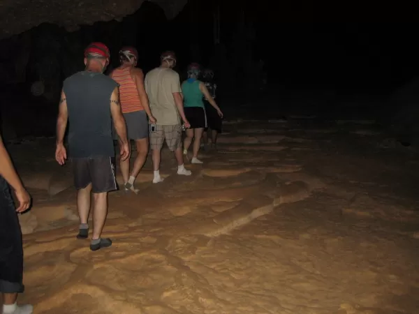 Travelers walking carefully through the ATM cave