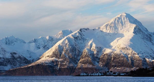The dramatic contrast of rugged peaks and tranquil waters that define the scenic beauty of the Norwegian archipelago.