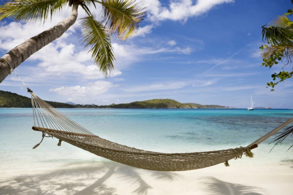 A white beach swing over clear turquoise water on Norman Island