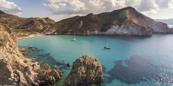 Volcanic landscape on Milos, Greek Islands, with clear water