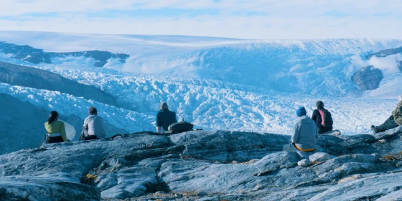 tourists observing majestic landscape of Sermilik Fjord