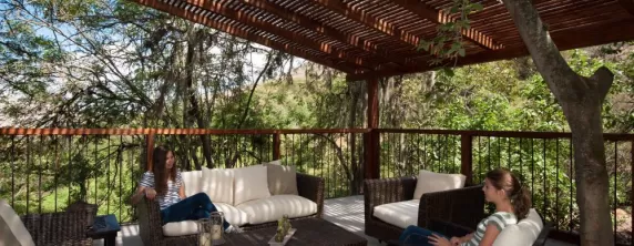 Relax in the covered outdoor lounge at Hacienda Piman