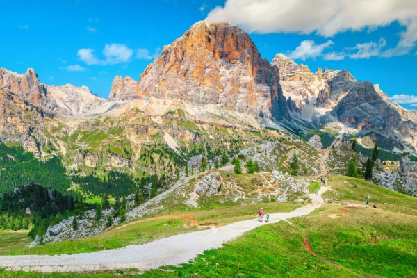 Hikers with backpacks walking on the mountain trails, Dolomites, Italy