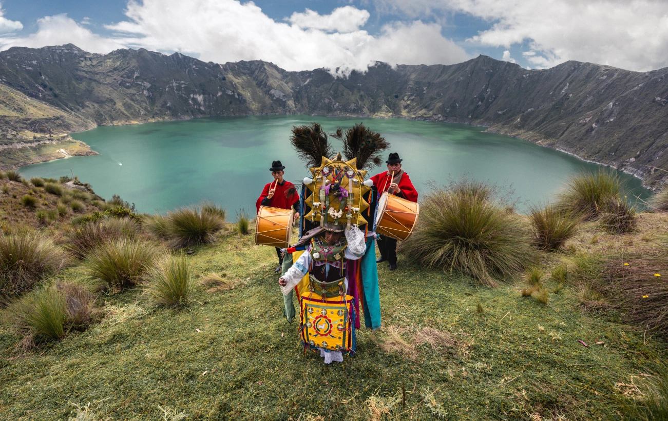 A traditional musical performance at the Quilotoa Lagoon in Ecuador, a volcanic crater lake known for its turquoise water
