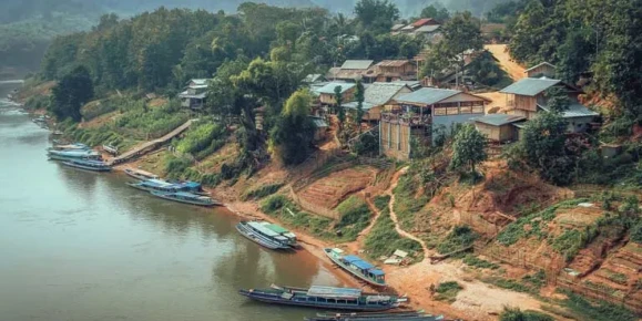 Pak Lai landscape, Mekong riverside village with boats and forested hills