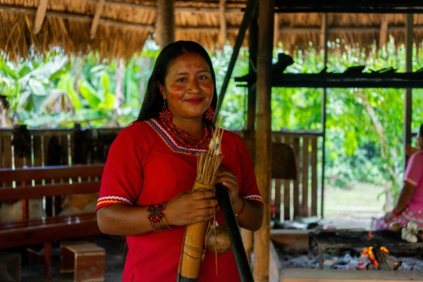 A Kichwa woman holds traditional pan pipes
