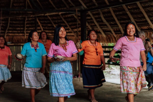 Kichwa women welcome guests in traditional dress