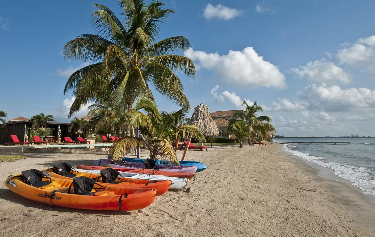 Complimentary kayaks wait ready for you on the beach at Hopkins Bay Resort