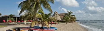 Complimentary kayaks wait ready for you on the beach at Hopkins Bay Resort