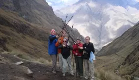 Travelers celebrating on the top of Dead Womans Pass on the Inca Trail