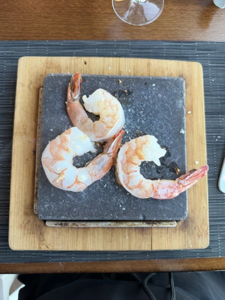 Cooking shrimp on a hot lava stone, Tuscan Grill, onboard Victory I