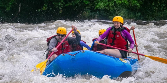 Erin and her family enjoying a whitewater rafting adventure on the Sarapiquí River in Costa Rica, navigating the river’s rapids together through the lush tropical rainforest.