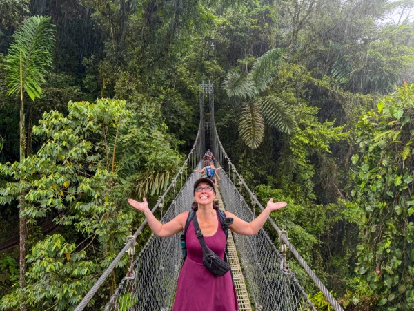Erin and her family exploring Mistico Arenal Hanging Bridges Park in Costa Rica, walking across suspension bridges and forest trails surrounded by lush tropical vegetation near Arenal Volcano.