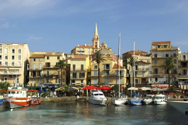View the historic harbor and serene waters of Calvi, Corsica