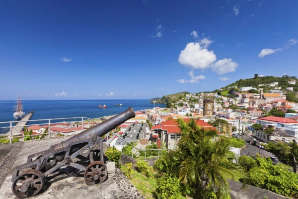St. George's harbor in Grenada, where historic cannons overlook scenic ocean views and colorful hillside estates
