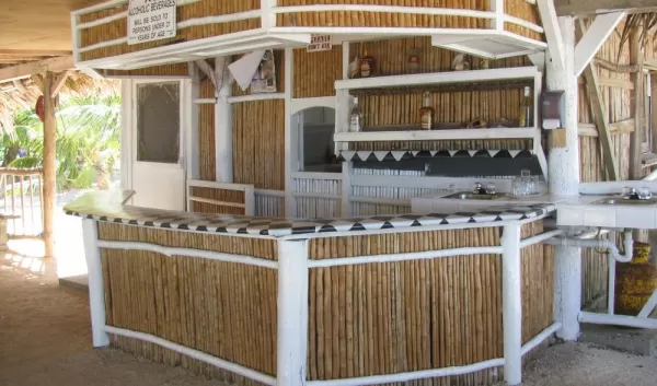 After a day of adventure, enjoy the open-air bar at Billy Hawk Caye