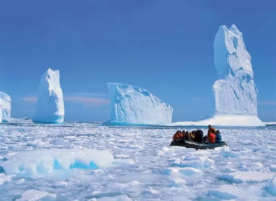 Zodiac cruising among the pack ice and icebergs of the peninsula