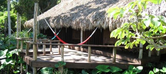 Relax on the deck at Lamanai Outpost Lodge